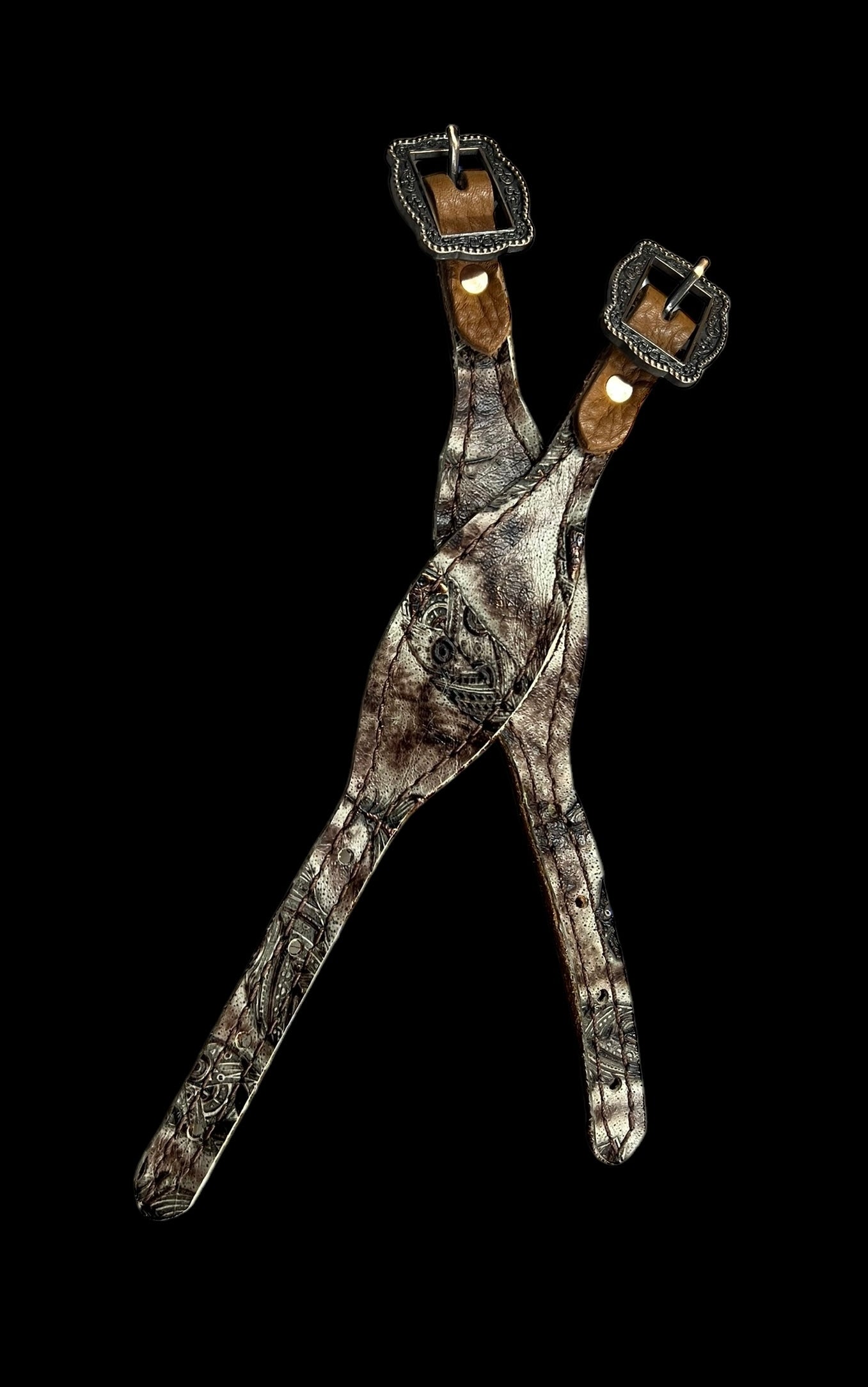 Cream and brown feathers on dark leather