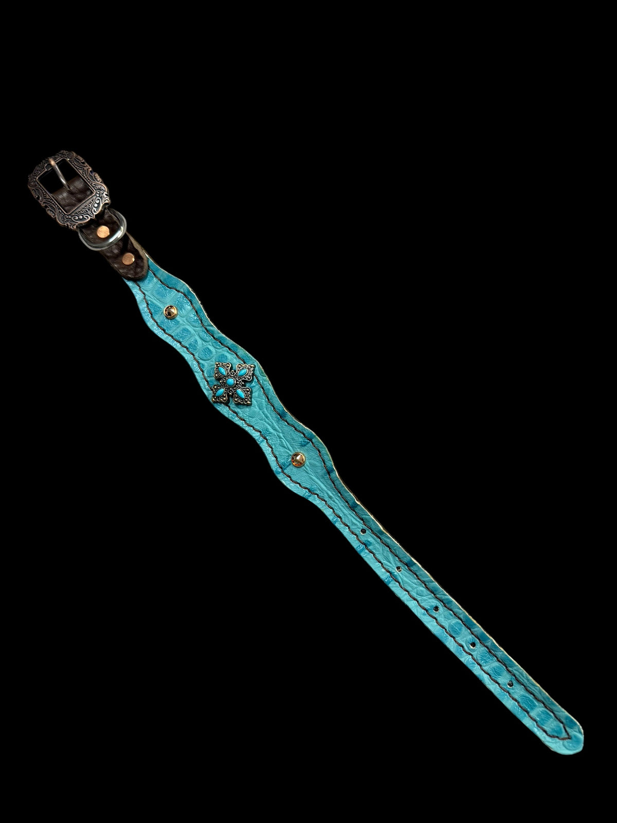 Turquoise gator on dark leather