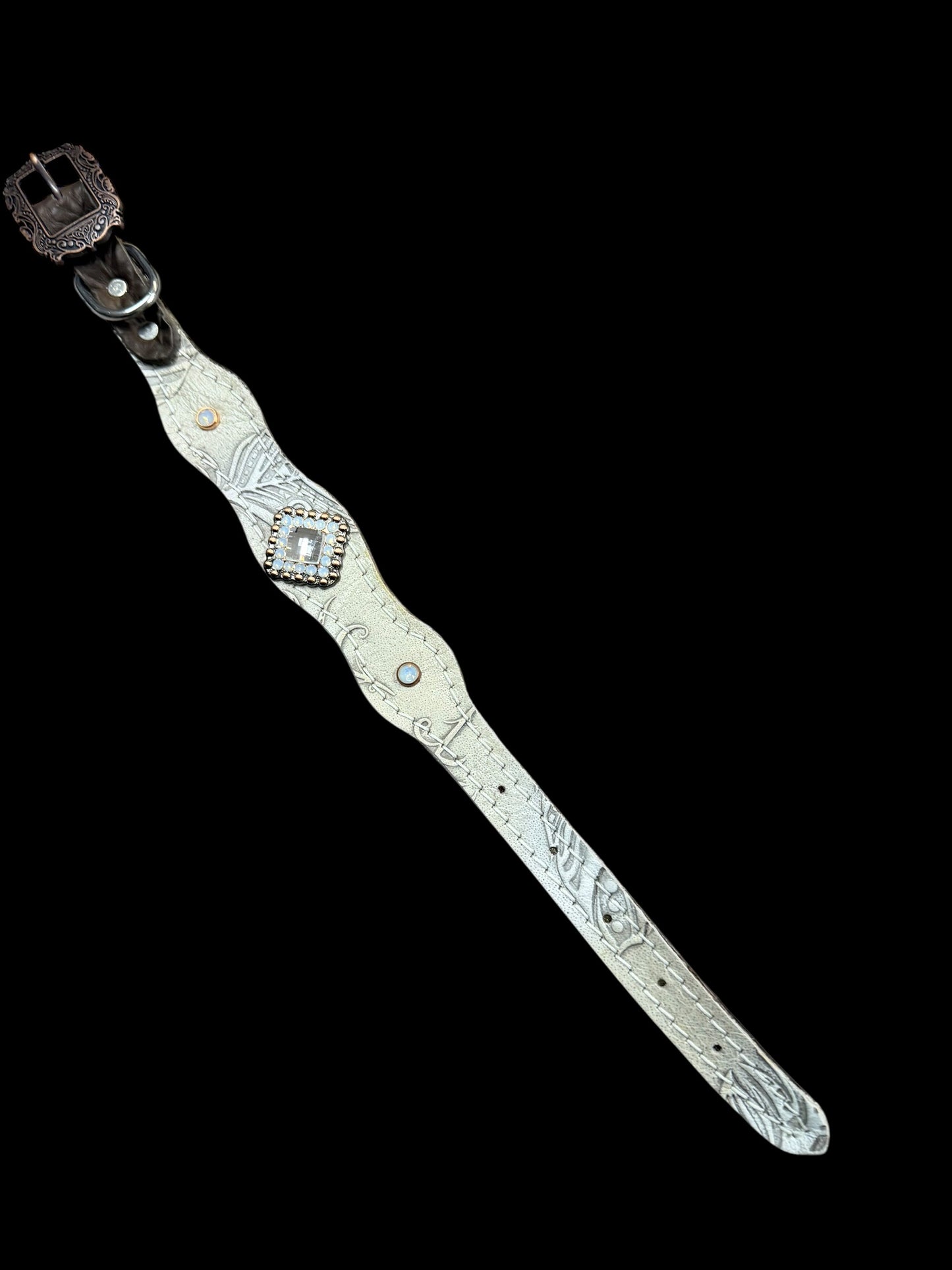 Cream feathers on dark leather