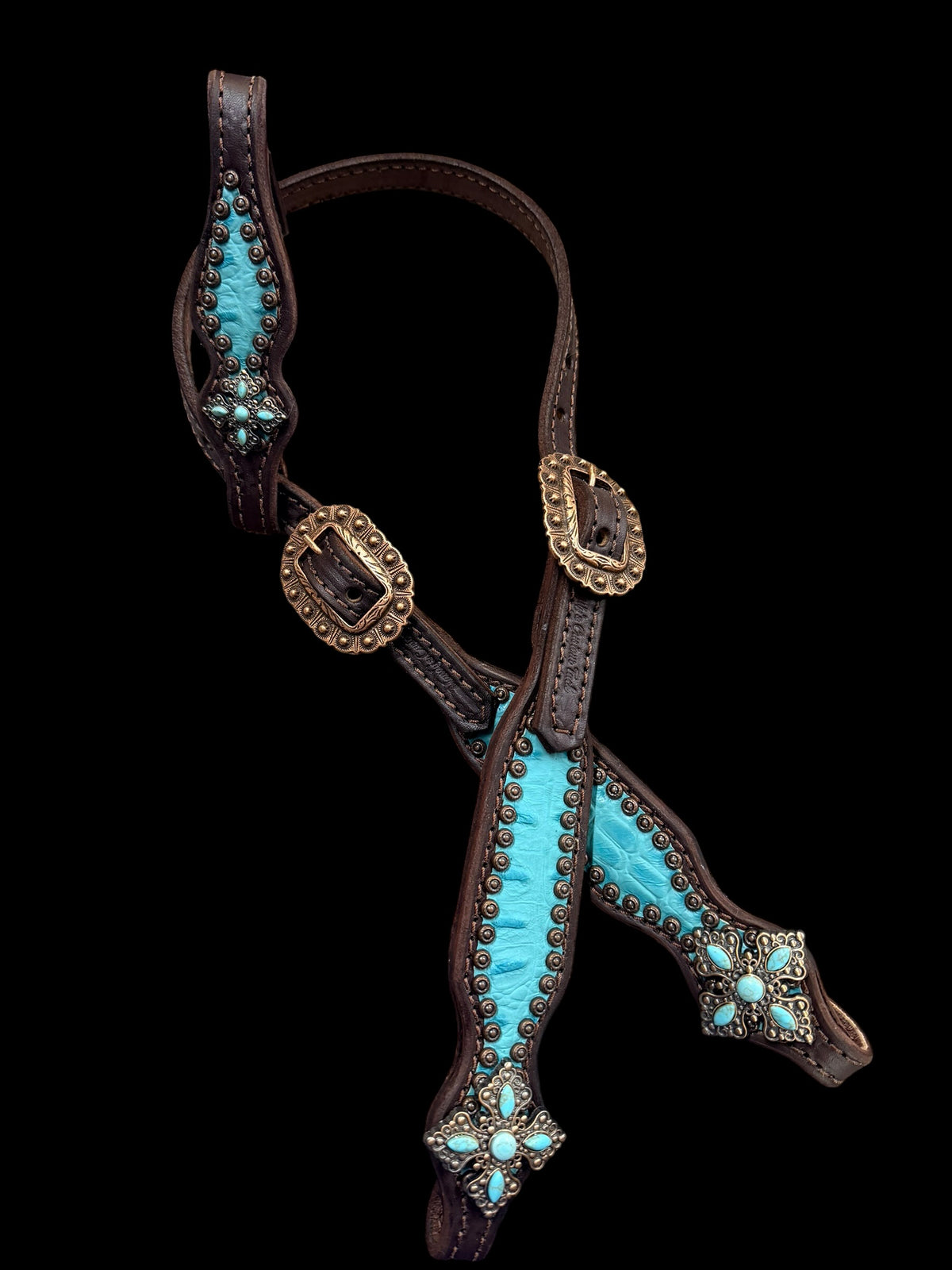 Turquoise gator on dark leather
