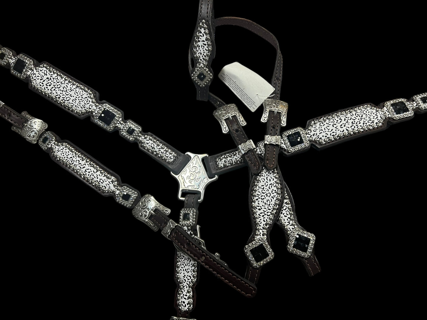 Snow leopard on dark leather