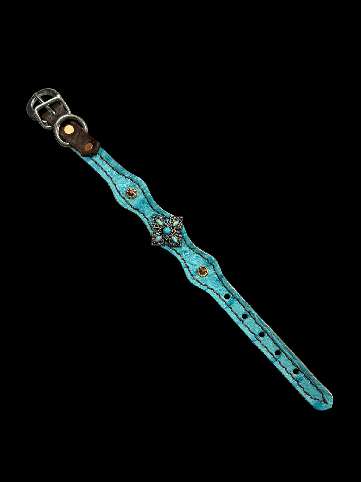 Turquoise gator on dark leather