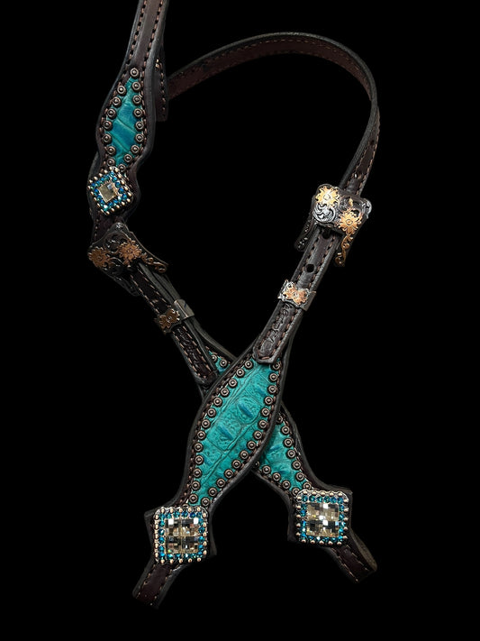 Teal gator on dark leather