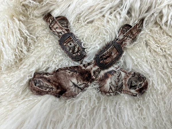 Cream and brown feathers on dark leather