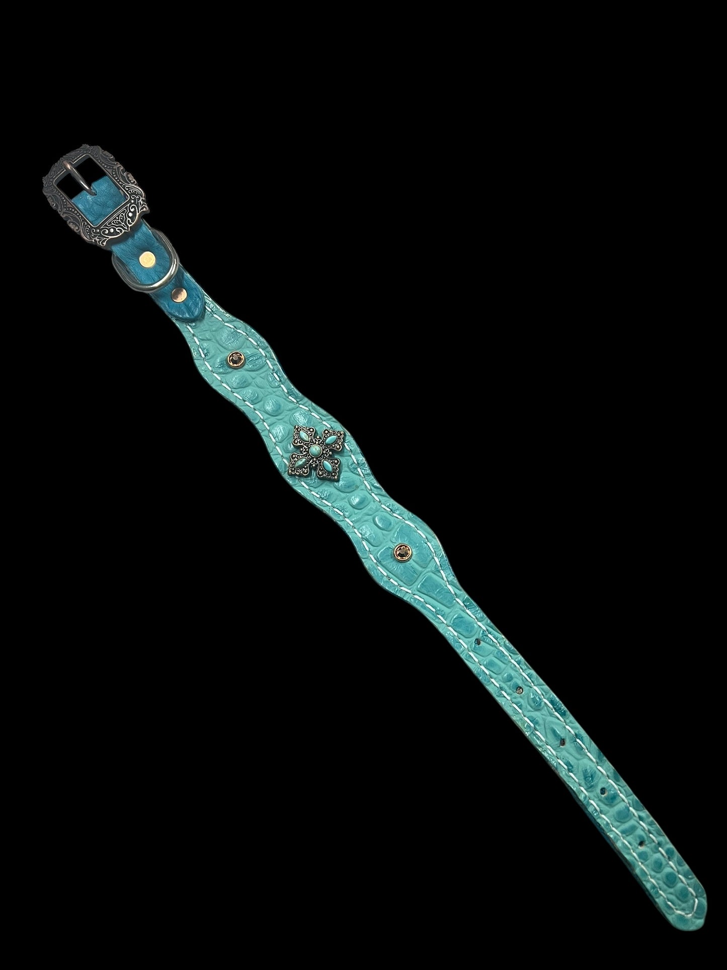 Turquoise gator on dark leather