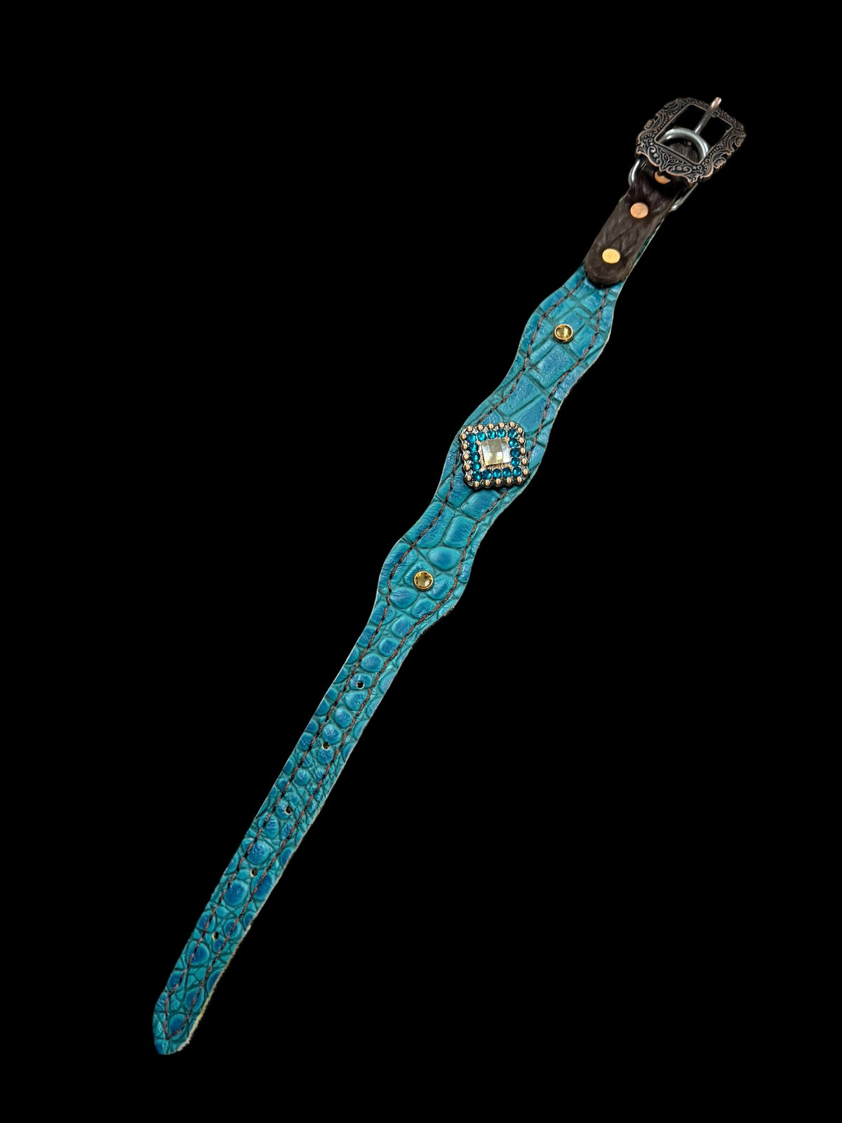 Teal gator on dark leather