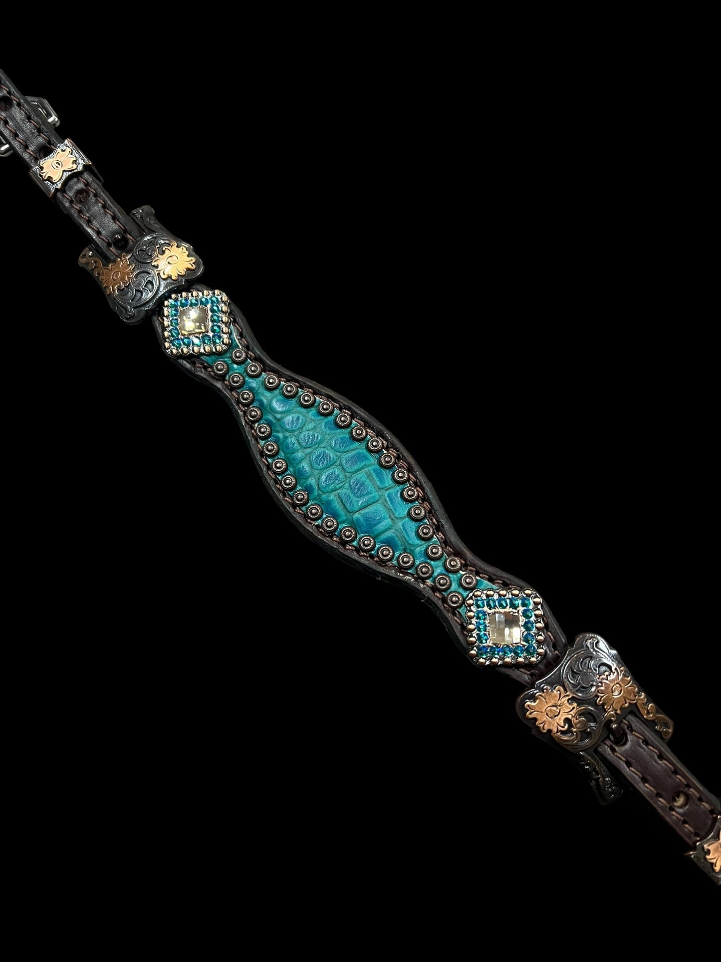 Teal gator on dark leather