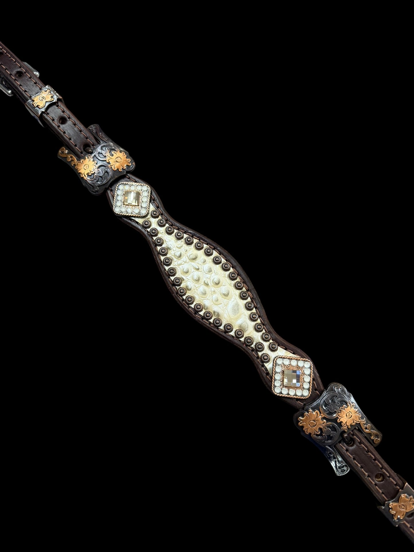 Champagne gator on dark leather