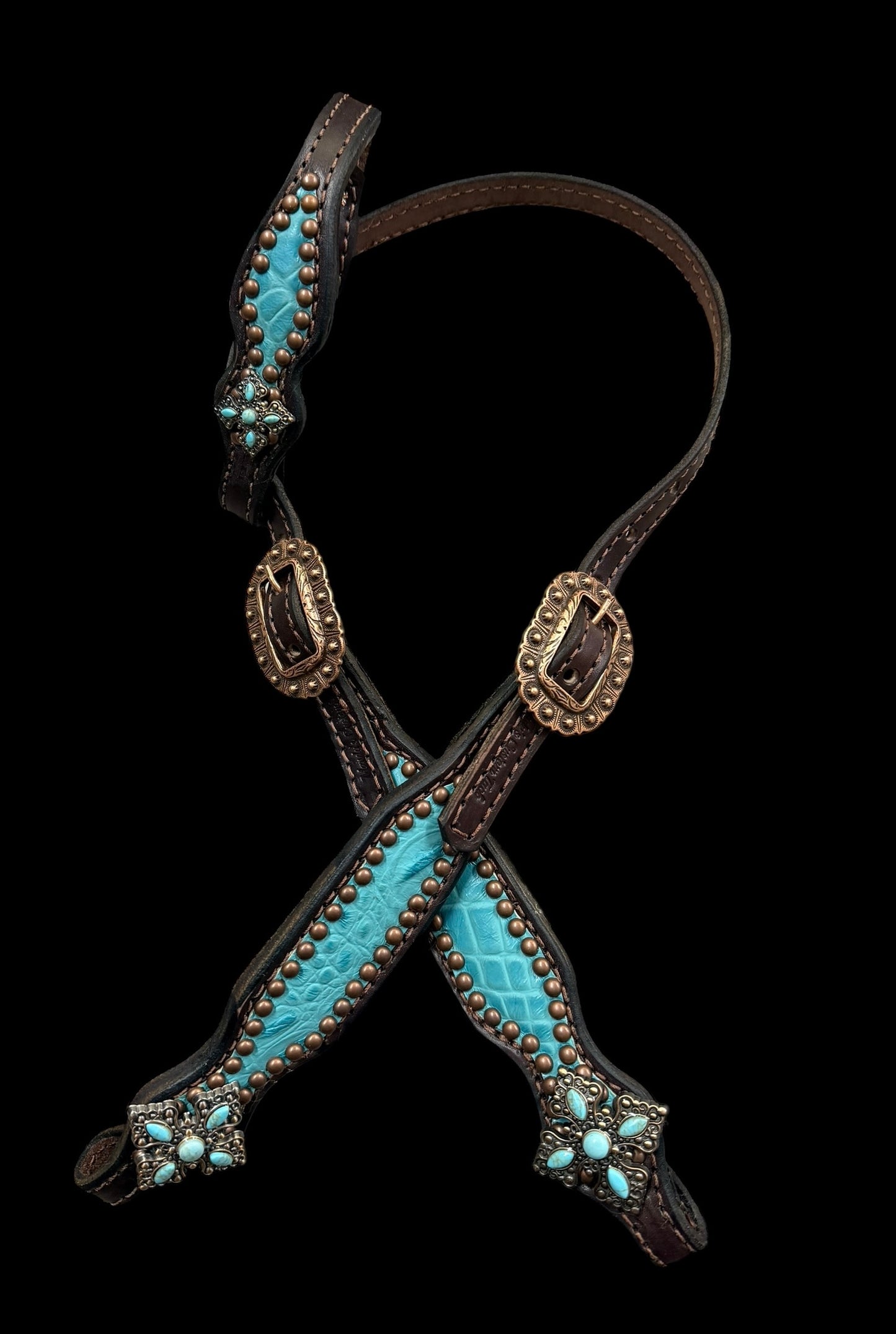 Turquoise gator on dark leather