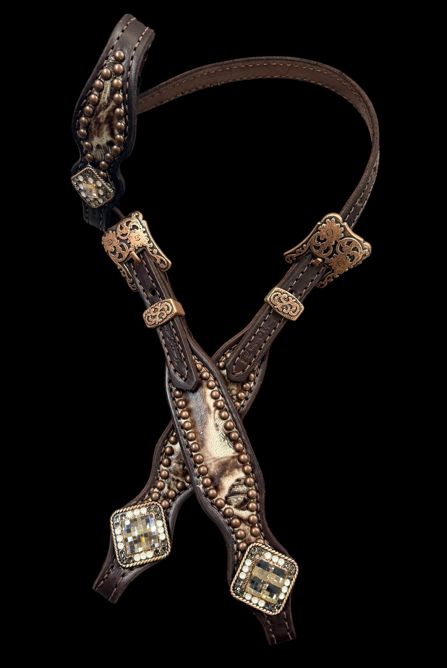 Cream and brown feathers on dark leather