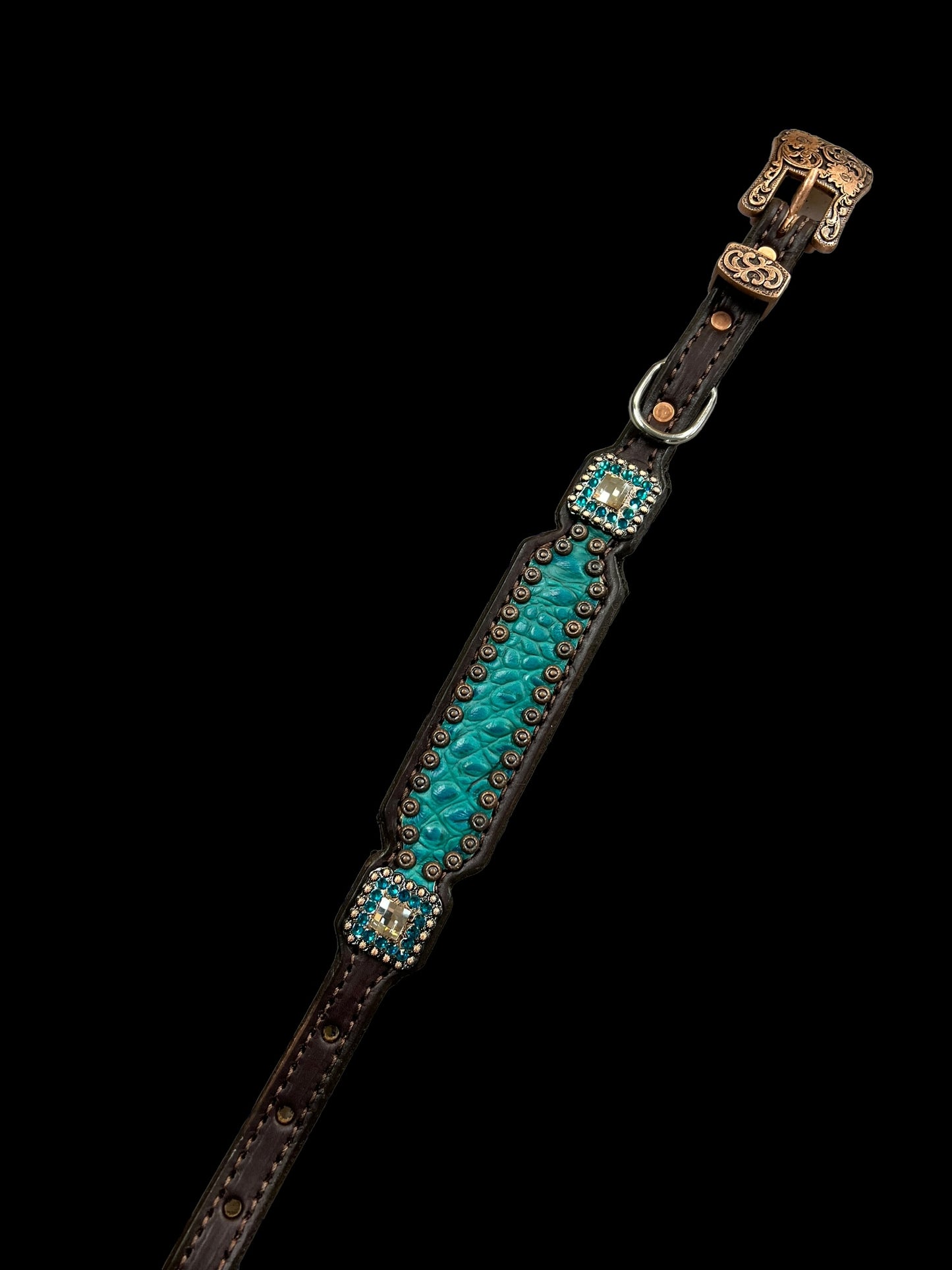 Teal gator on dark leather