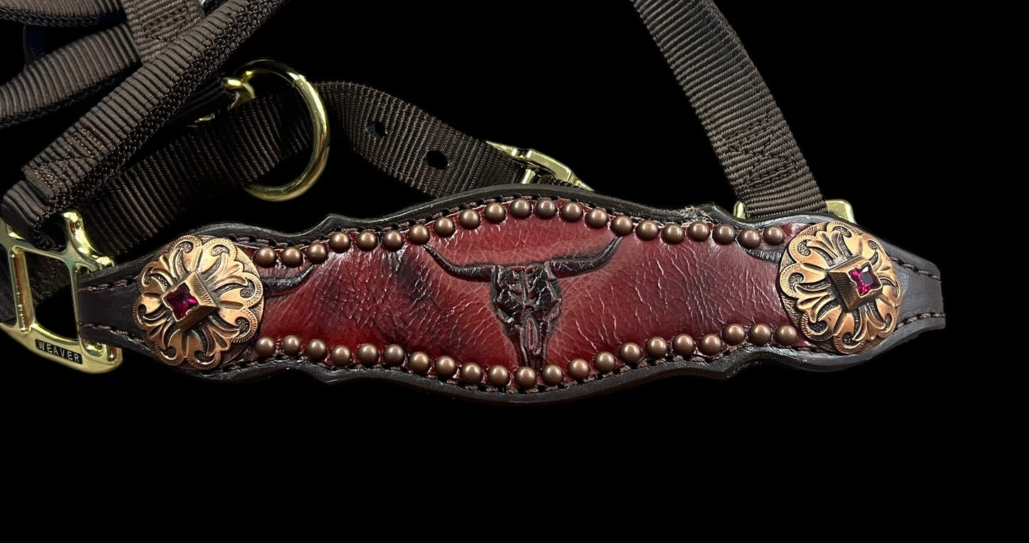 Red longhorns on dark leather