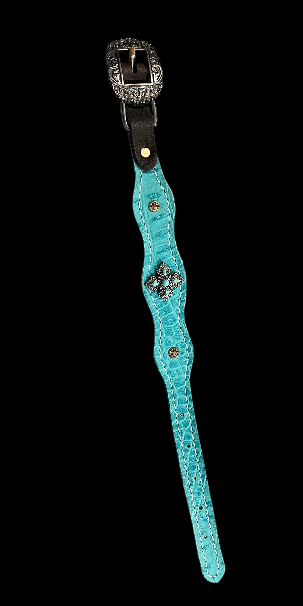 Turquoise gator on dark leather