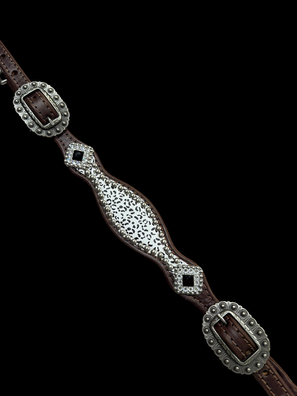 Snow leopard on dark leather