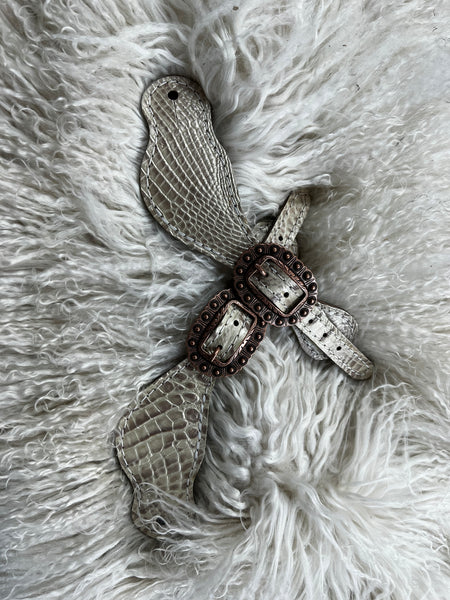 Champagne gator on dark leather